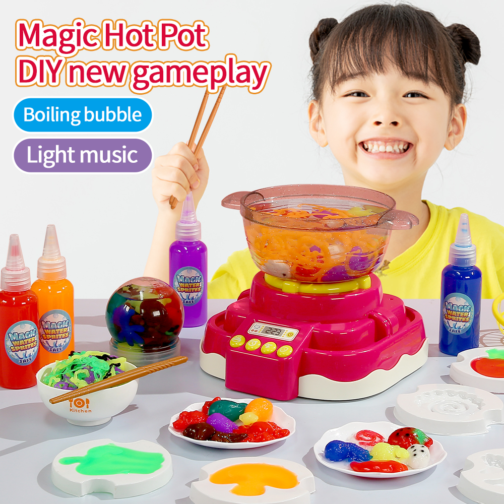 A little girl smiles as she plays with the Magic Hot Pot Water Spirit Set, holding chopsticks in her hand