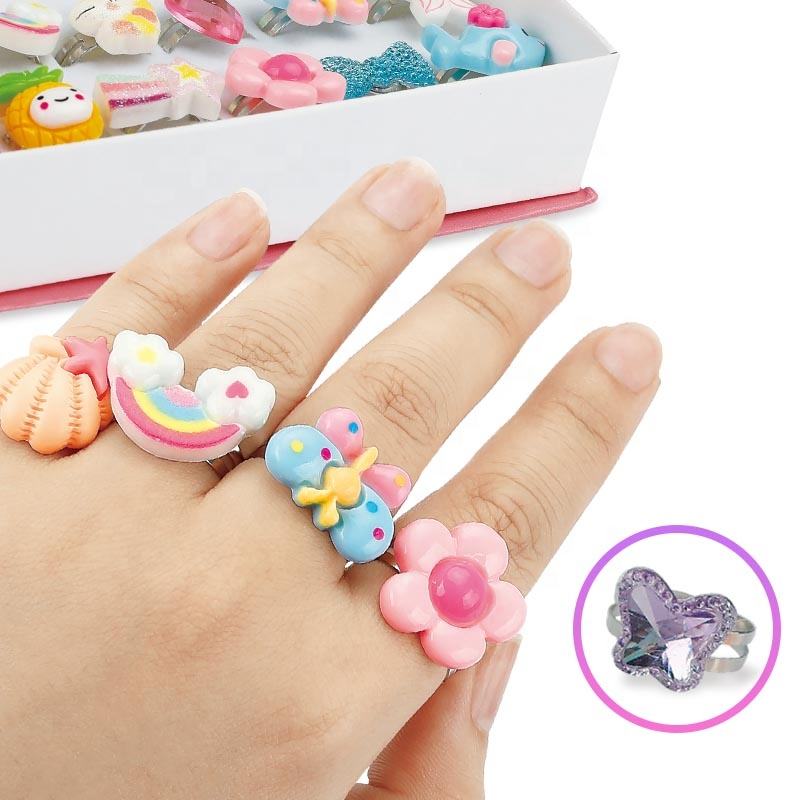 One hand adorned with four adorable ring toys of different designs