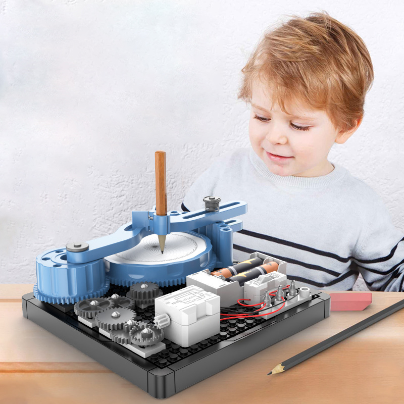 A child in a striped outfit is using a Circuit Machinery Drawing Instrument on the table