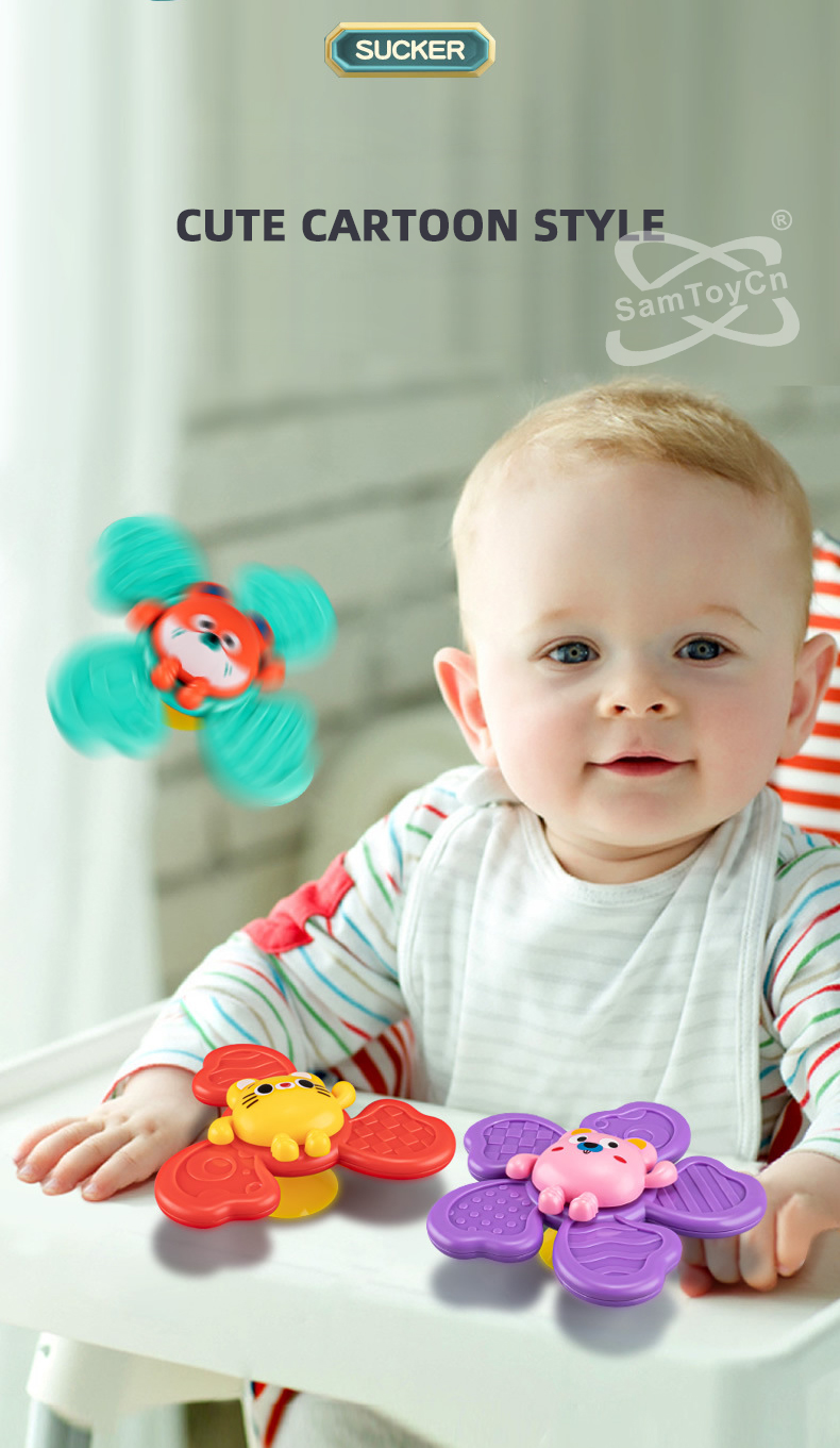 The infant sits in the baby chair playing with three suction cup spinning top toys
