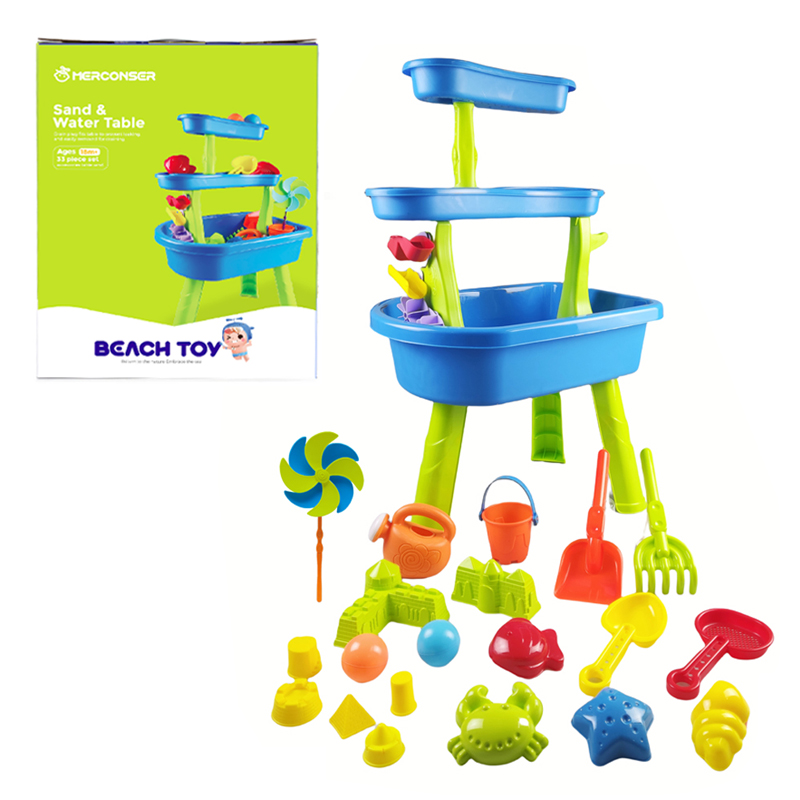 The blue-green Sand & Water Table with a bunch of colorful beach toys and its outer packaging