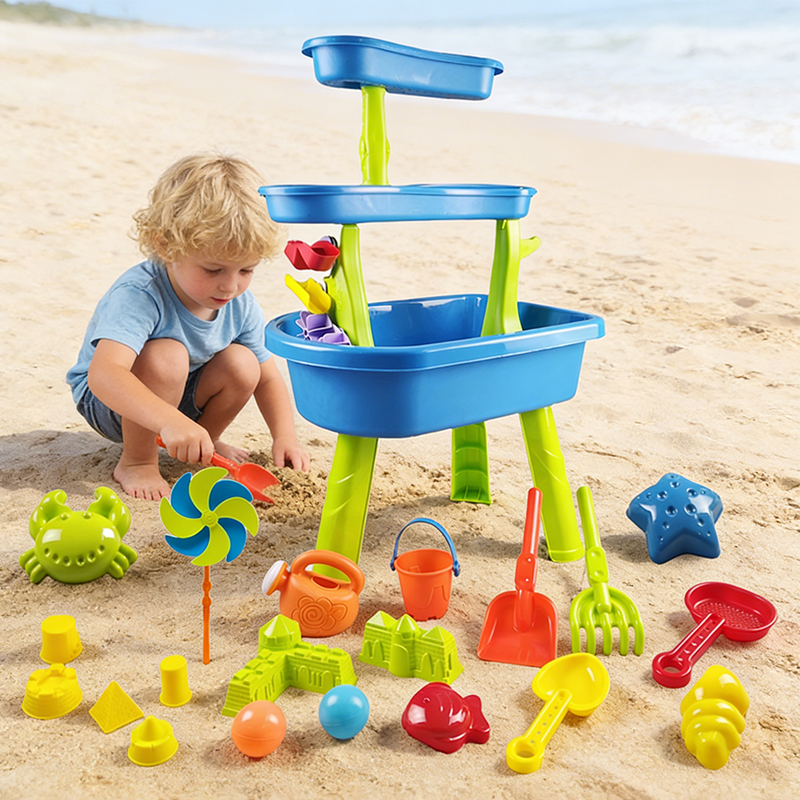 A little boy in gray clothes crouched by the seaside, digging in the sand and playing at the Sand & Water Table