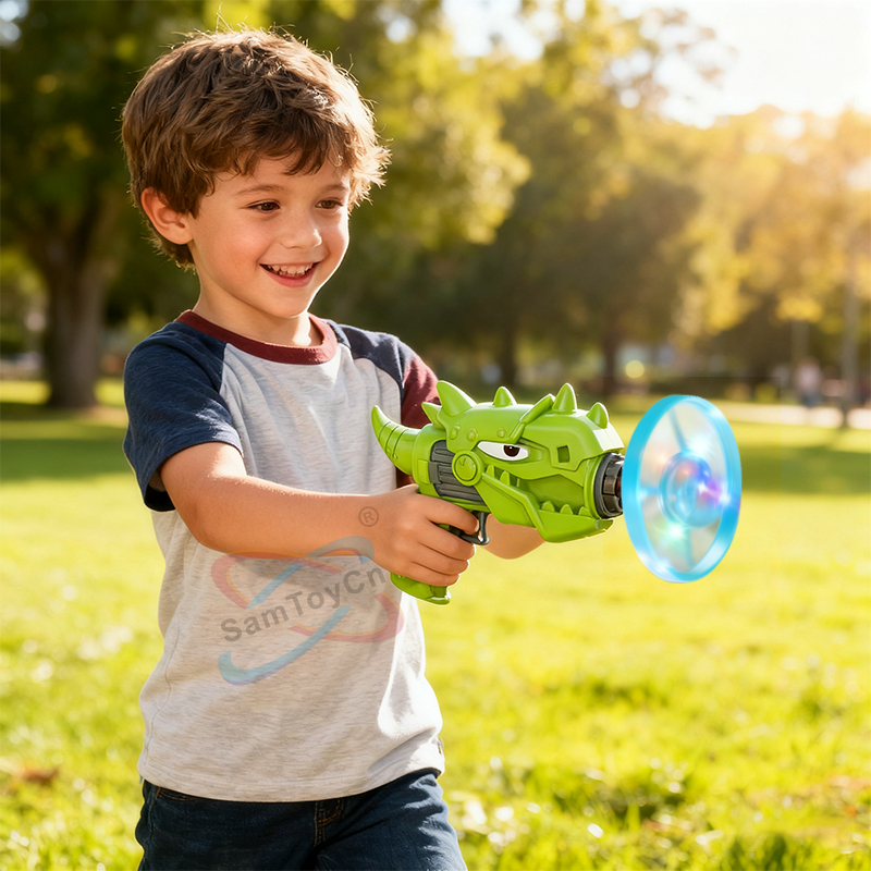 A little boy stands on the grass, holding a green Flying Saucer Gun and firing blue flying saucers