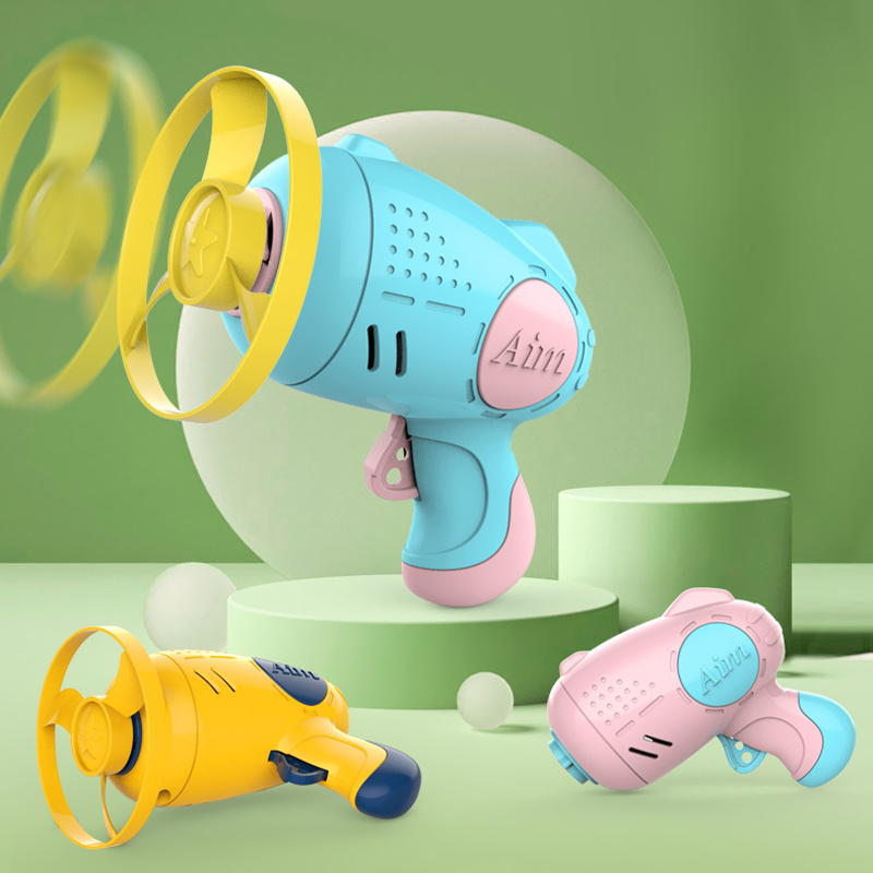 Three colors of the Flying Saucer Gun against a green background