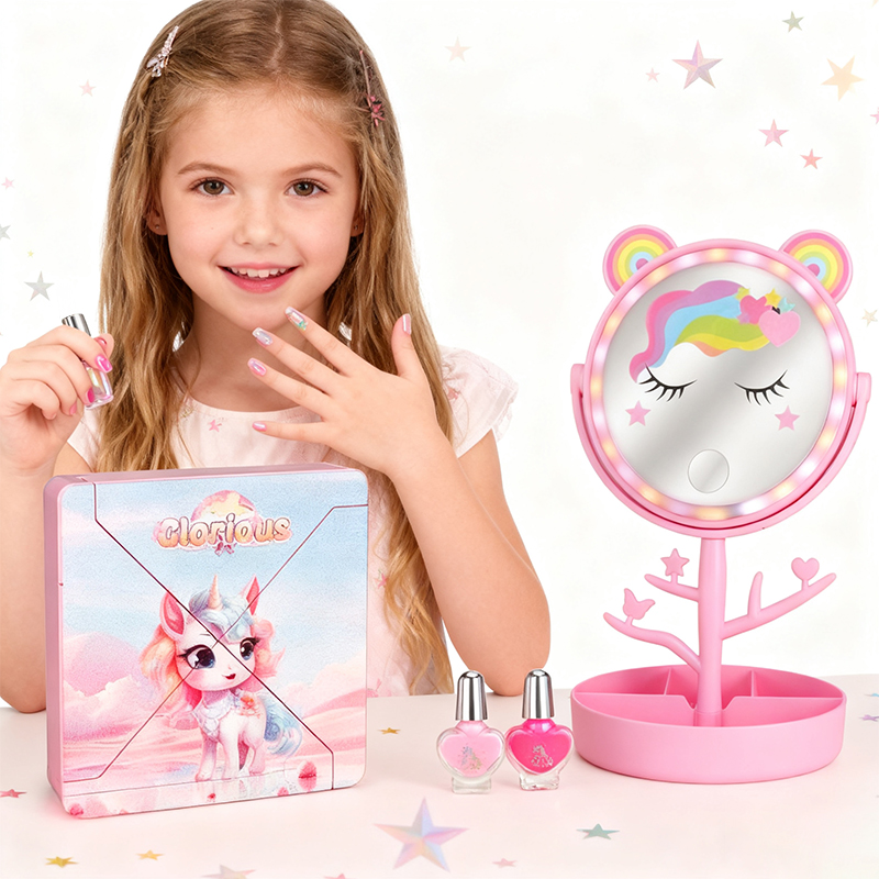 A little girl sits at a table using a makeup set and shows her fingers painted with nail polish