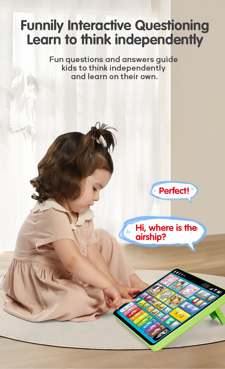 A little girl in a pink dress sits on the floor interacting with a Tablet Learning Machine