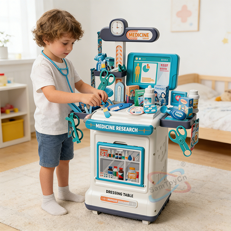 A little boy in gray clothes is playing with the Play House Medical Cart Set toy in the room