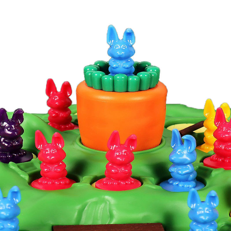 A group of toy bunnies surround a blue toy bunny standing atop a plastic carrot