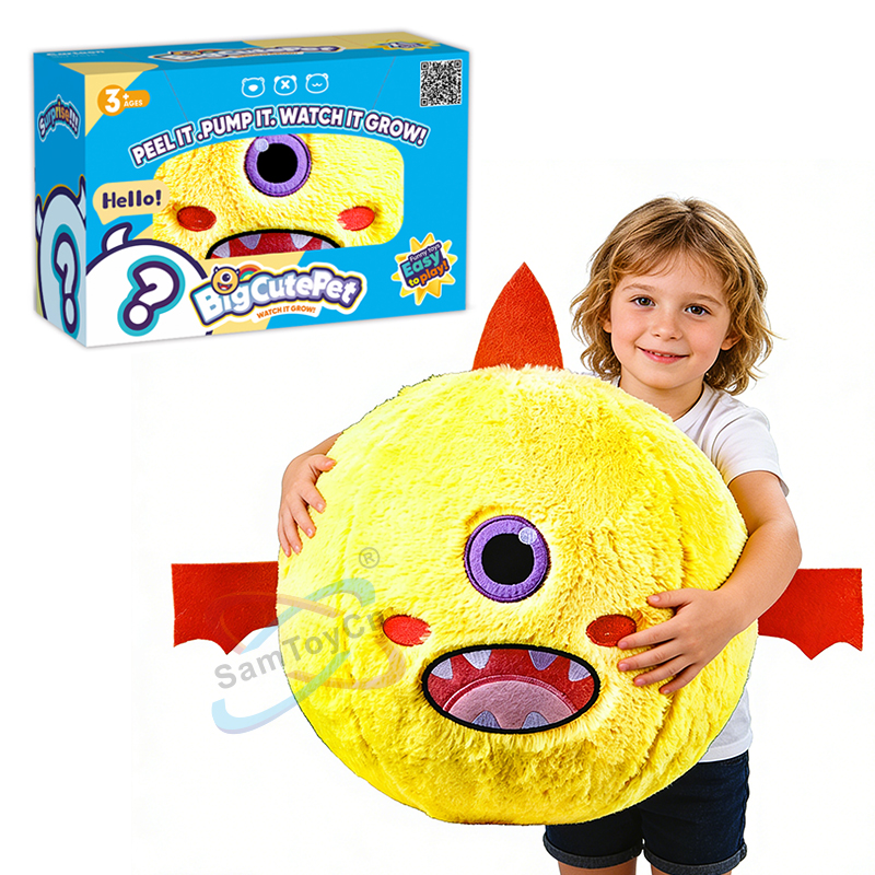 A little boy in white clothing is holding a yellow Small Size Devil Plush Ball, with the product's outer packaging beside him