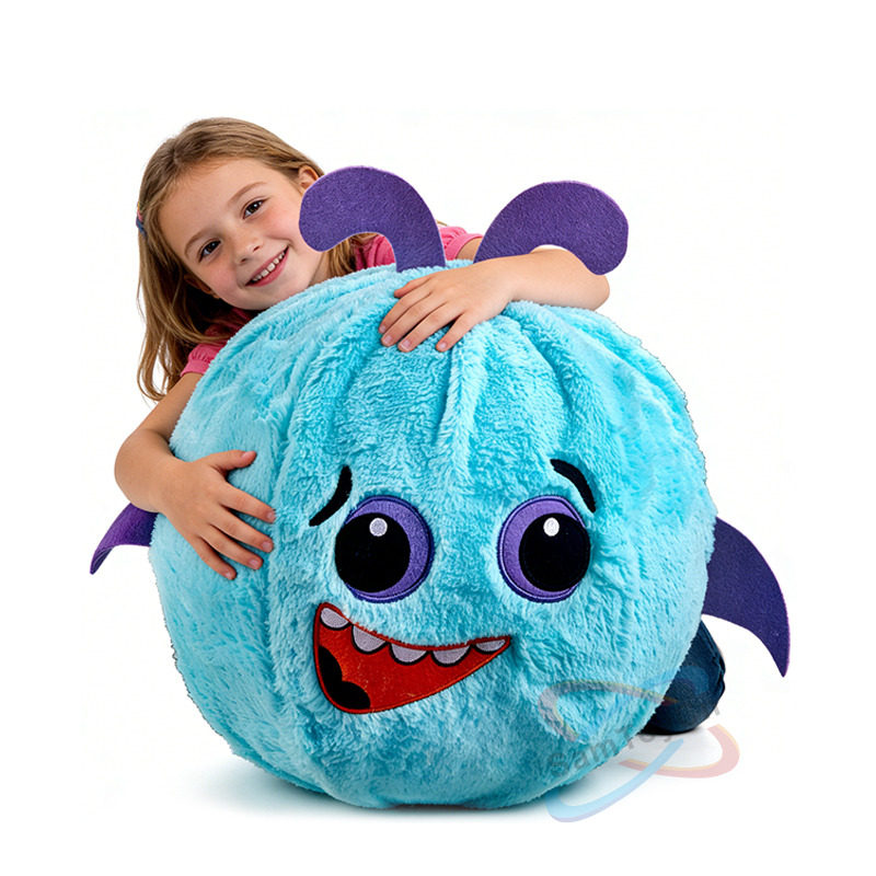 A little girl in a pink outfit smiles while hugging a blue Small Size Devil Plush Ball